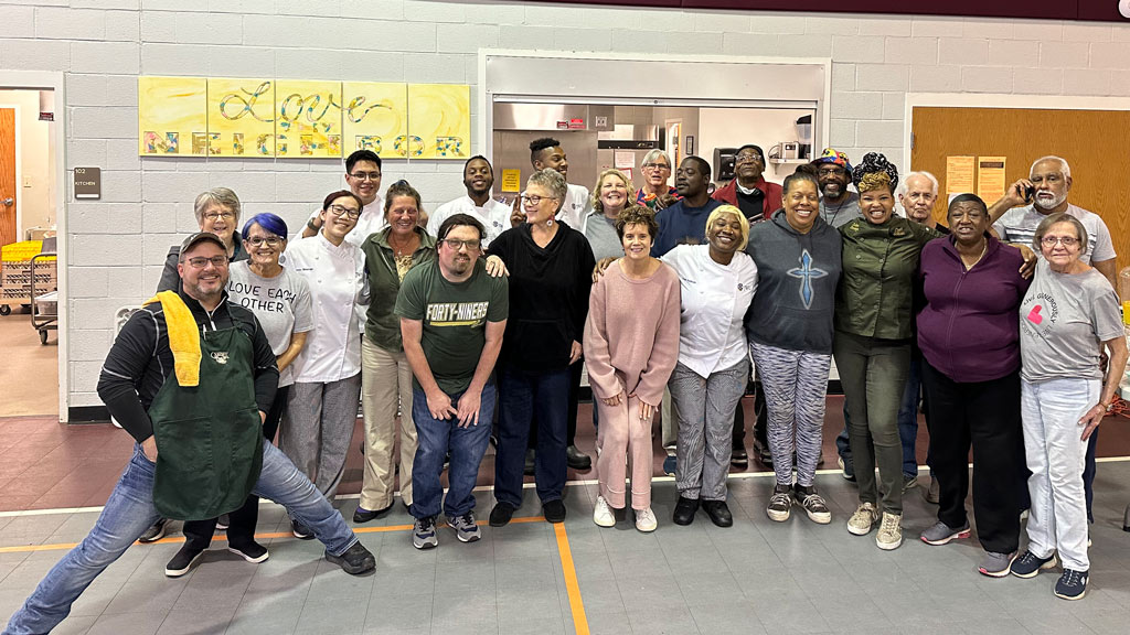 a group photo of JWU's Food Recovery Network members posing with clients