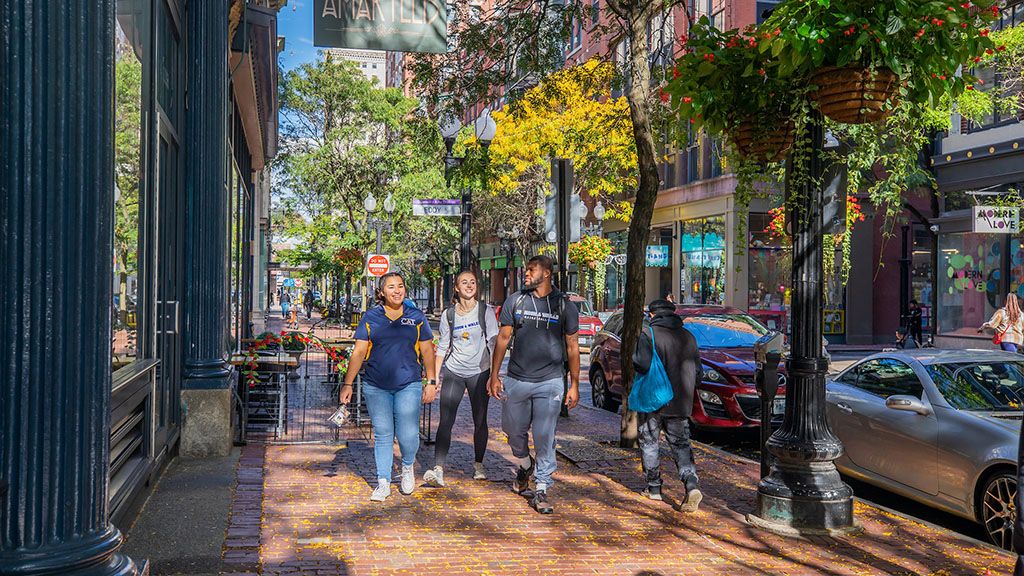 Three students walking down Westminster Street in Providence