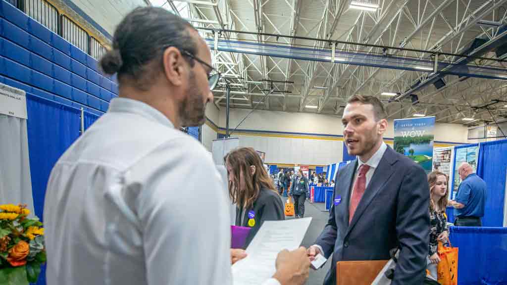 Students networking with industry representatives.