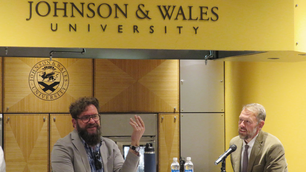 a photo of Michael Cimarusti and Dean Jason Evans having a conversation in an ampitheatre