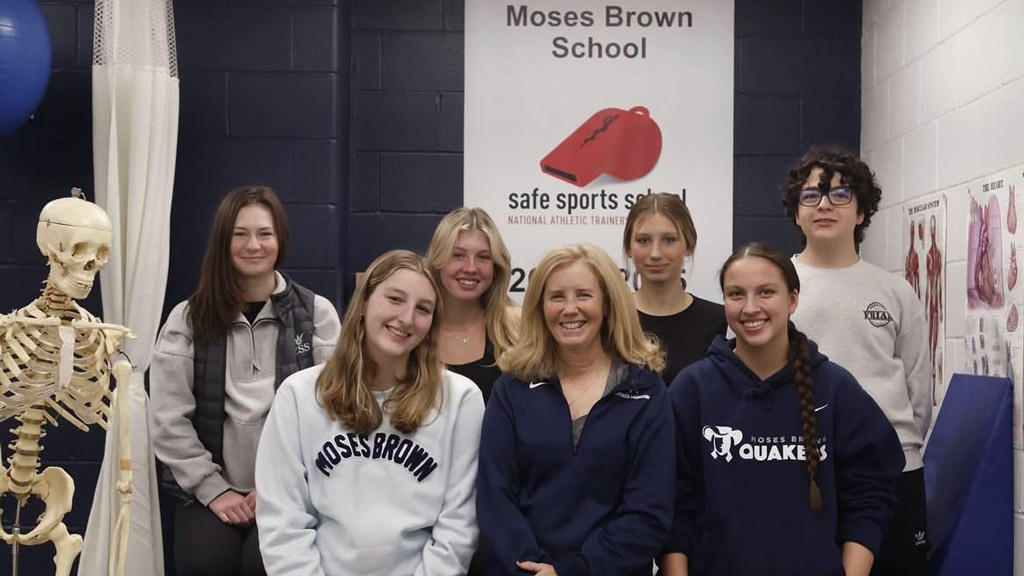 a group photo of students and an athletic trainer at Moses Brown School