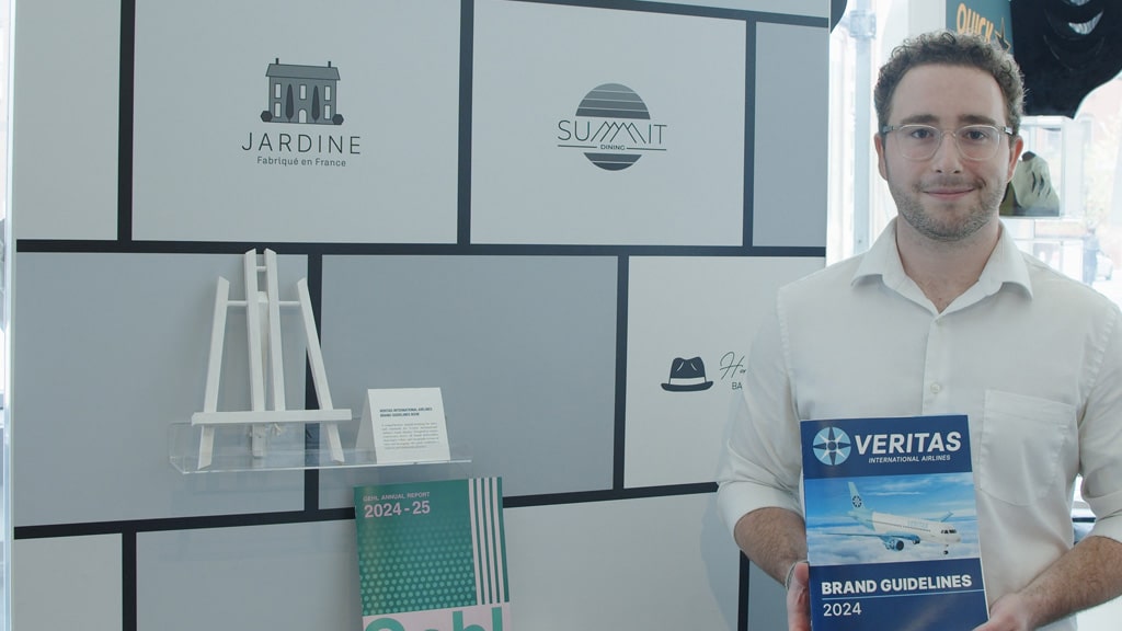 Caption: Matteo Lopergolo ’25, shows off the brand standards guidebook he created.