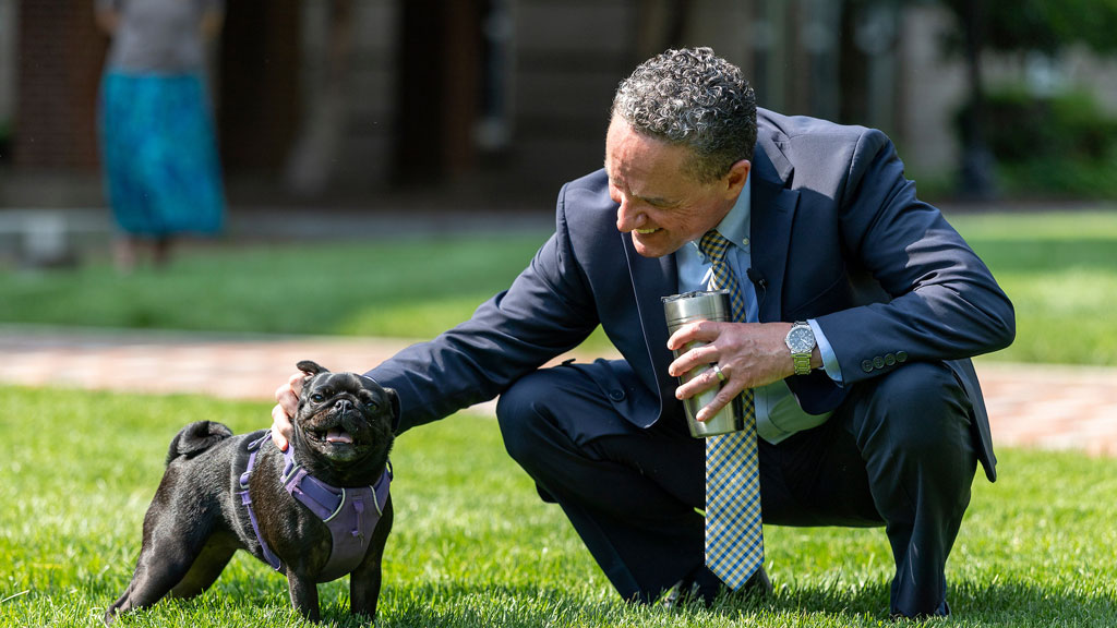 JWU Providence President Joseph Greene petting a dog