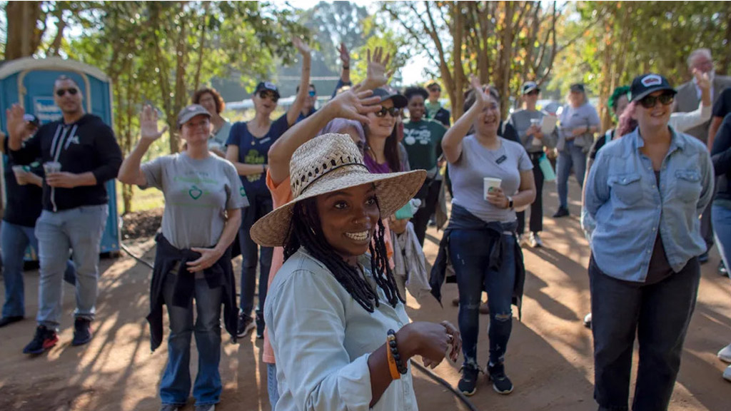 photo of Mariah Henry '19 surrounded by various people in an outdoor environment
