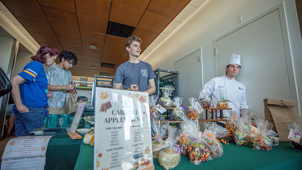 Students serving candy apples