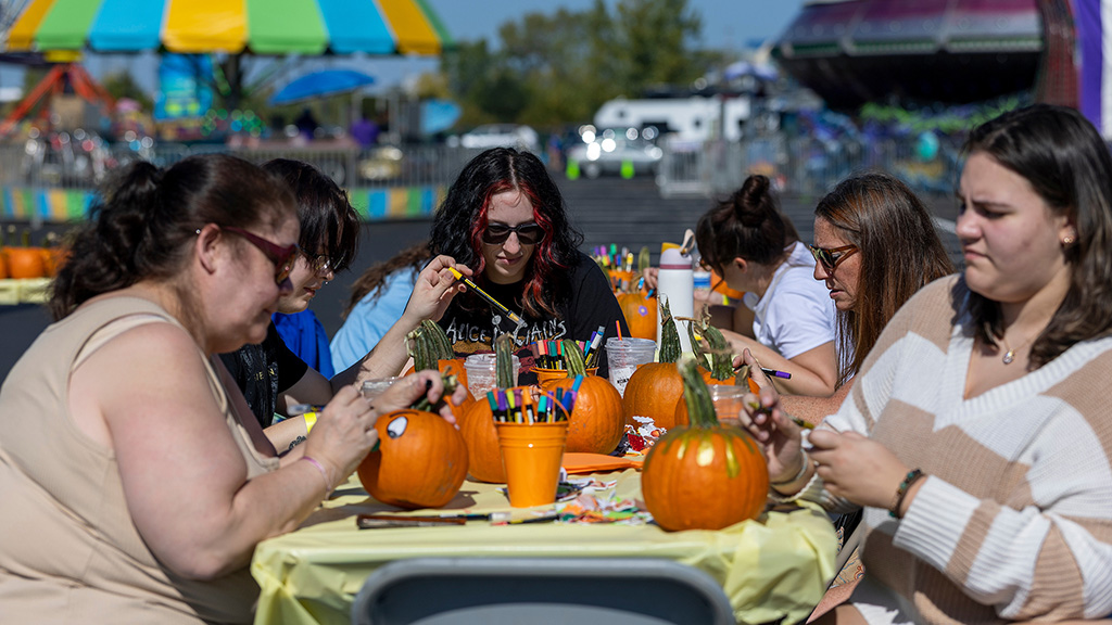 Students painting pumpkins