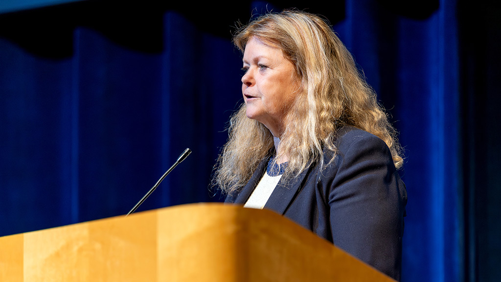 Dean Maura Daley Iversen speaks at a podium at the ABSN pinning