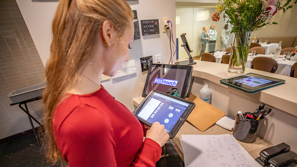 Student in the Bistro on an iPad