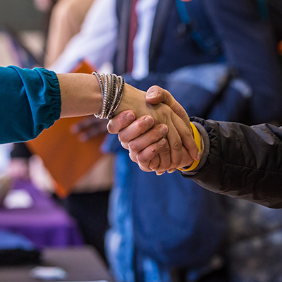 closeup photo of two hands shaking