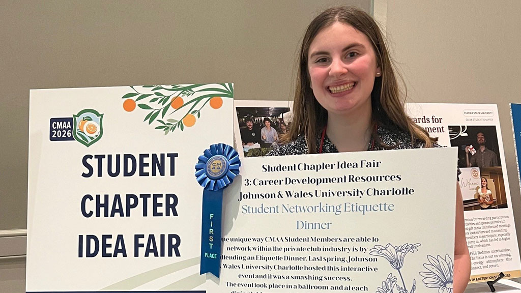 Cara Martino'26 with her winning idea and posterboard for Student Networking Etiquette Dinner
