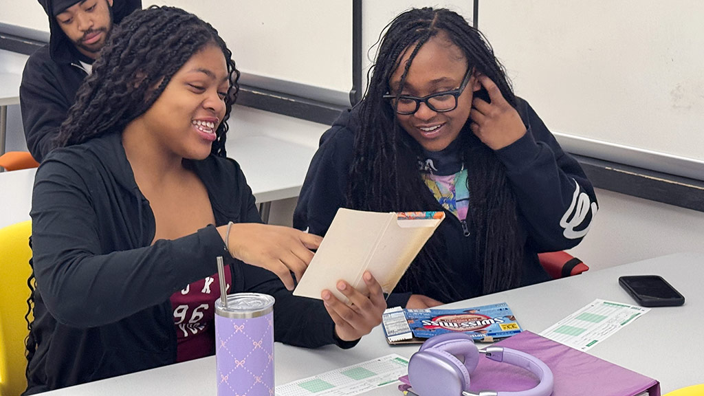two students at a table work on a culinary nutrition activity
