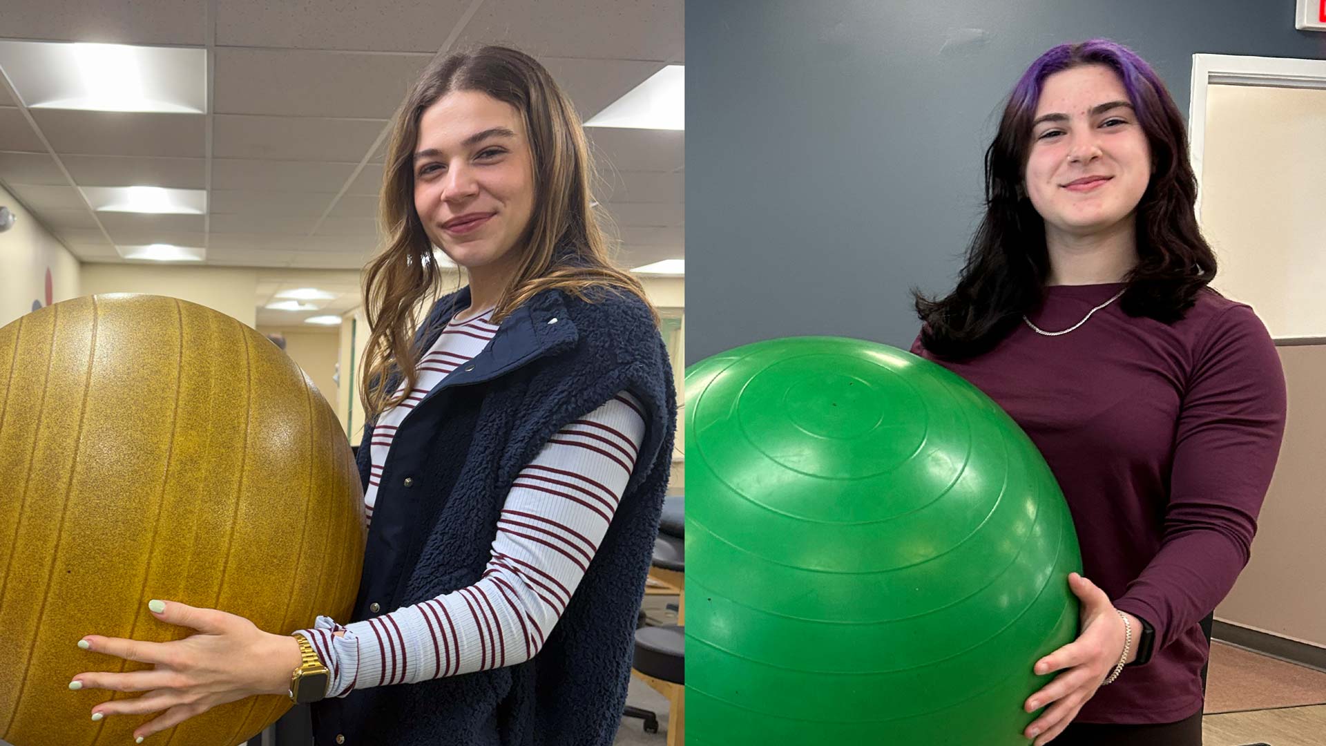 Kerra and Sofia both holding exercise balls smiling at the camera