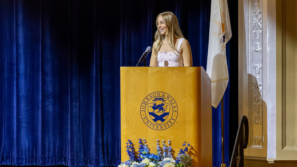 Katherine "Katie" Mayhew ’27 MSPAS speaks at a podium