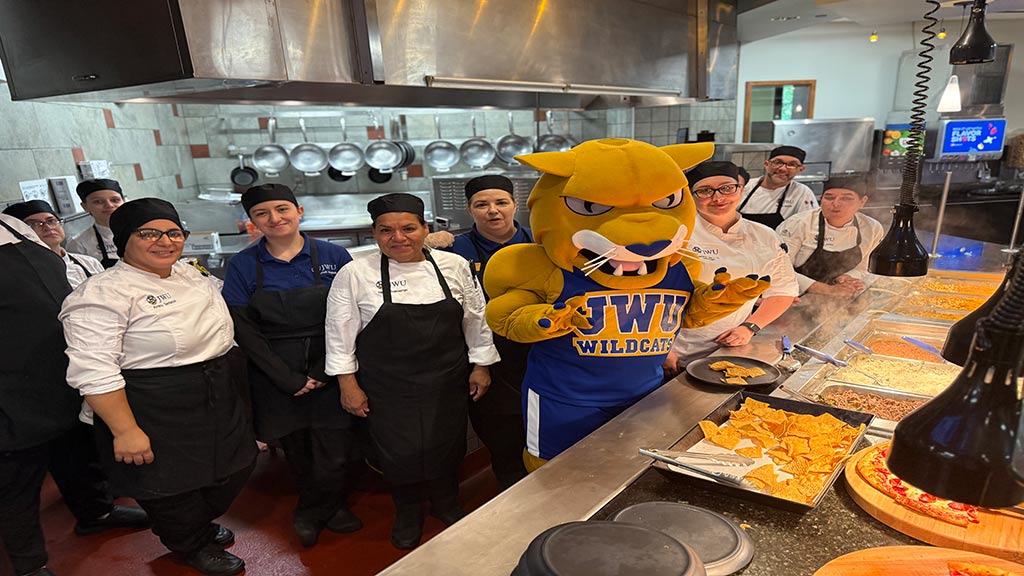 Wildcat Willie in kitchen with staff