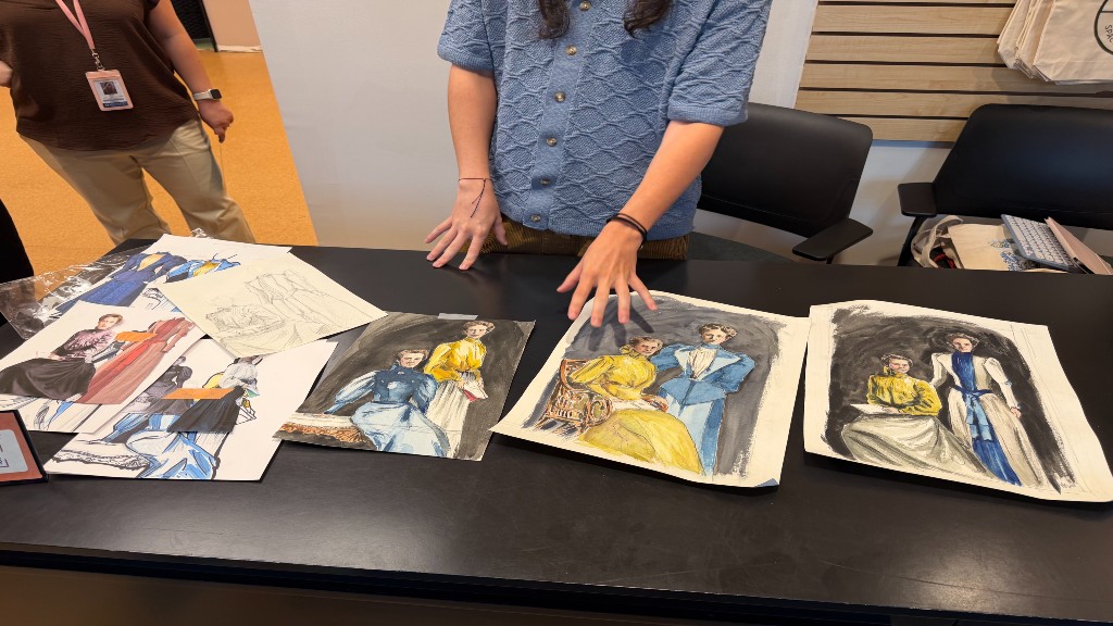 Victor Aguirre Williams showing sketches for portrait