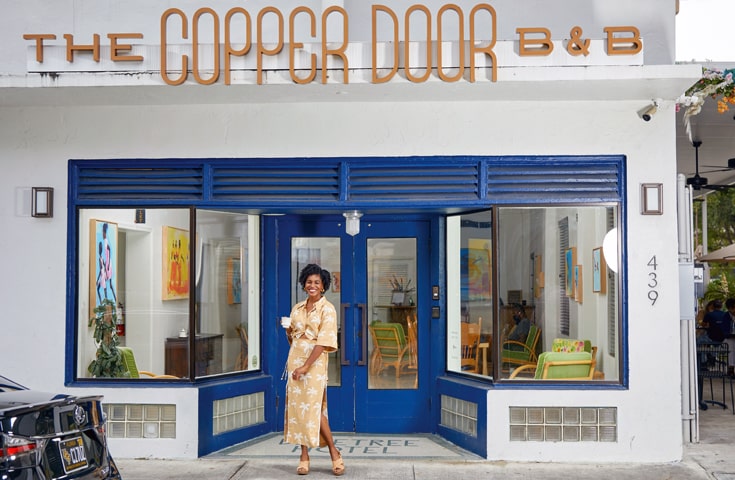 Exterior of The Copper Door with the owner outside