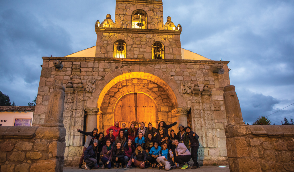 Group of JWU students in front of historic Ecuador church
