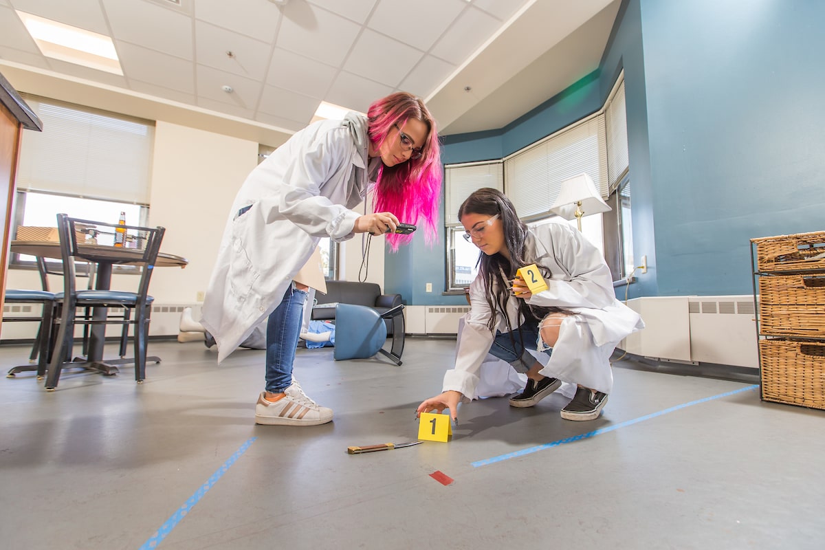 Students using interactive Crime Scene Room at JWU